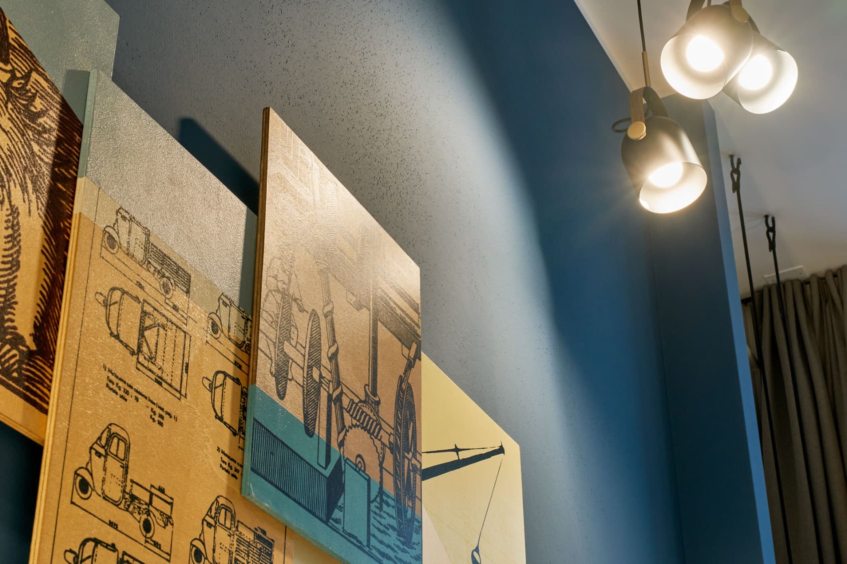 Seen is a detailed picture of the art pieces that hang in the street lofts. Each loft is inspired by its previous usage of the space, so the art shows scences and tools from those shops.